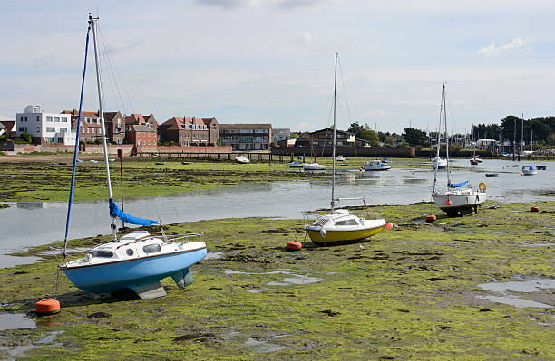 Boats on beach at low tide in Emsworth. Hampshire. England