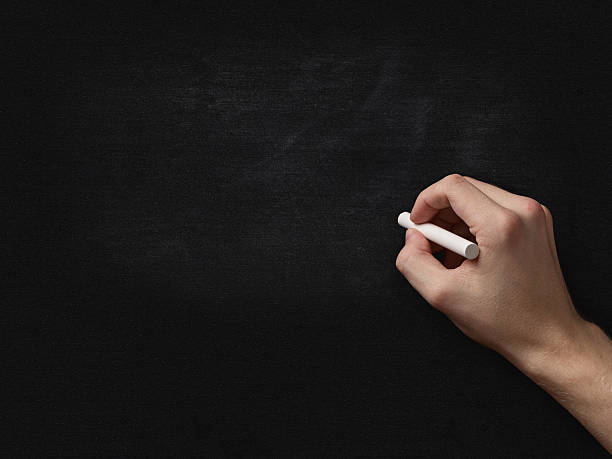 istock adult man hand to draw something on blackboard 462209355