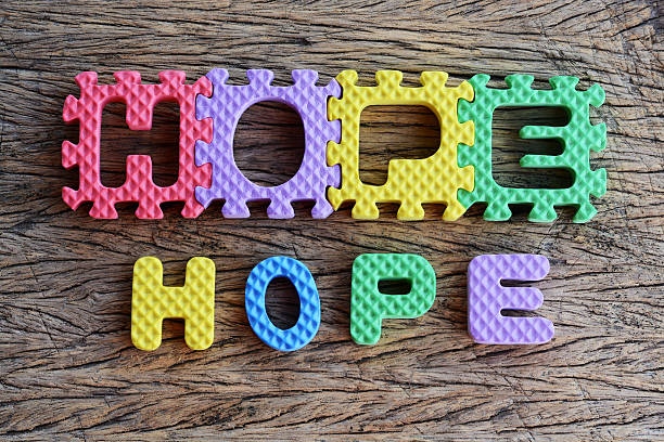 istock jigsaw written hope word on wood background 462210053