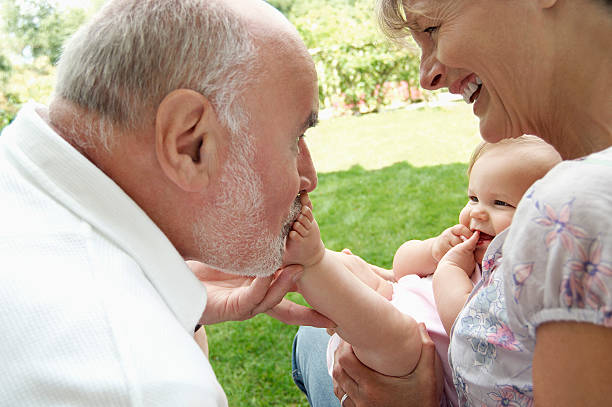 istock Elderly couple playing with young toddler 462221575