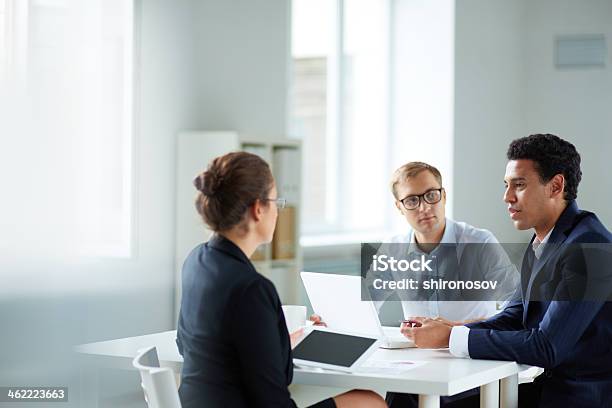 Businesspeople In A Planning Work Meeting Stock Photo - Download Image Now - Job Interview, Technology, Discussion