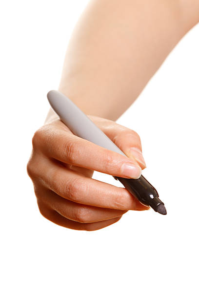 istock Woman's hand with black marker writing on a white 462224271