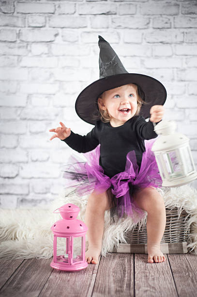 istock Halloween little girl witch with lanterns 462232389