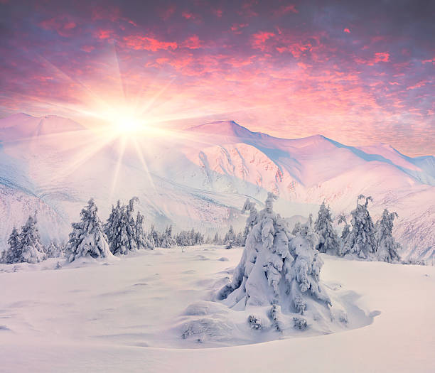 istock Winter sunrise in snowy mountains 462243175