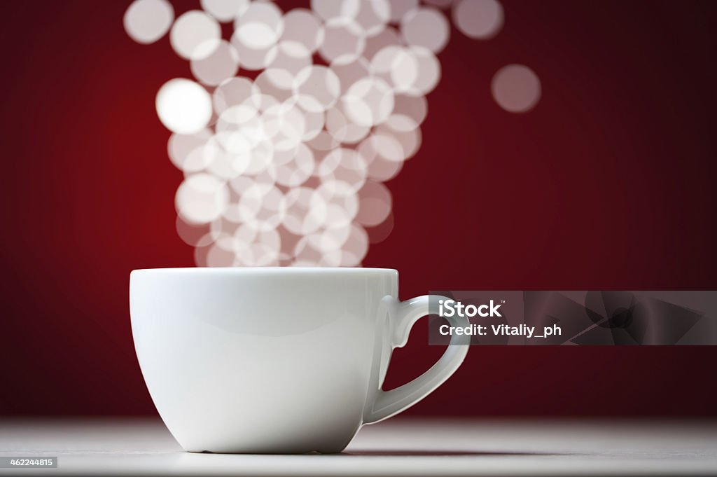 Defocused lights as aroma emanates from white coffee cup Defocused lights as aroma emanates from white cofee cup Abstract Stock Photo