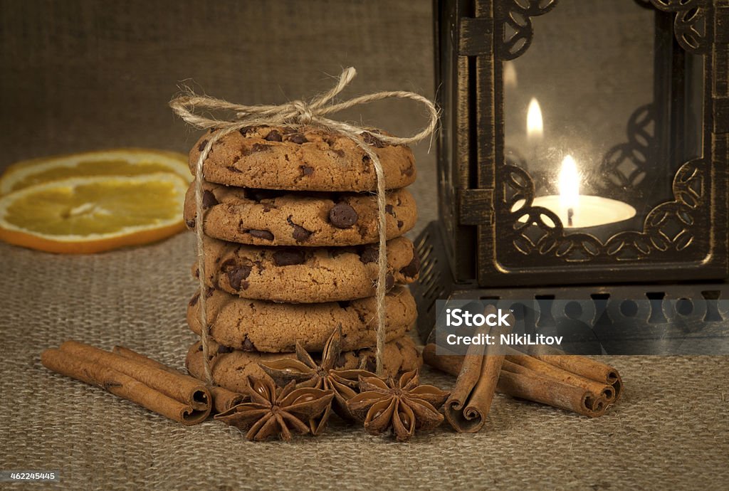 Christmas Cookies Christmas cookies with spices and candle on a brown background. Advent Stock Photo