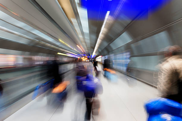 istock motion blurred travellers, passage way at airport Frankfurt / Main 462249341