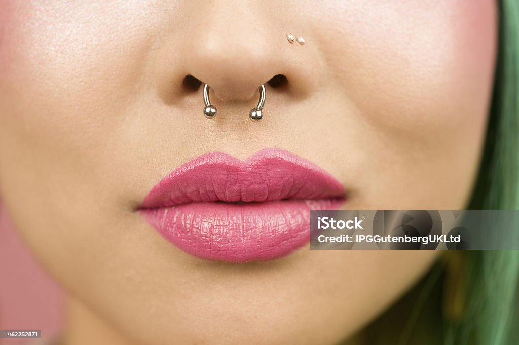 Lips of young woman wearing pink lipstick Nose Ring Stock Photo