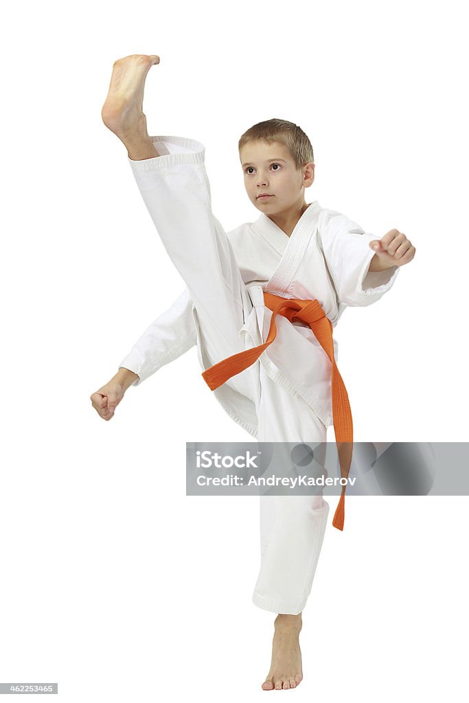 Boy in kimono beat a high leg kick Boy in a kimono beat a high leg kick Activity Stock Photo