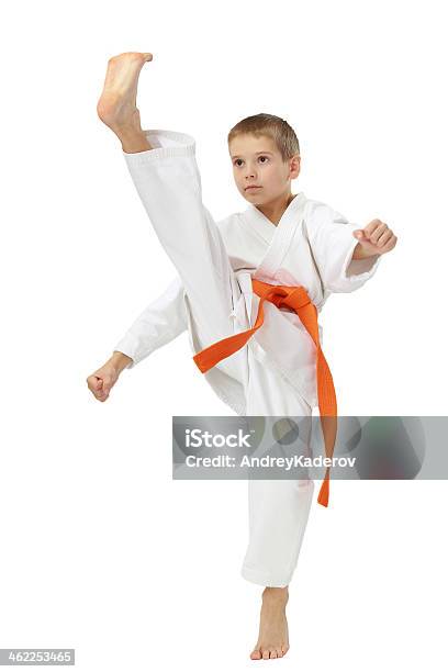 Boy In Kimono Beat A High Leg Kick Stock Photo - Download Image Now - Activity, Athlete, Belt