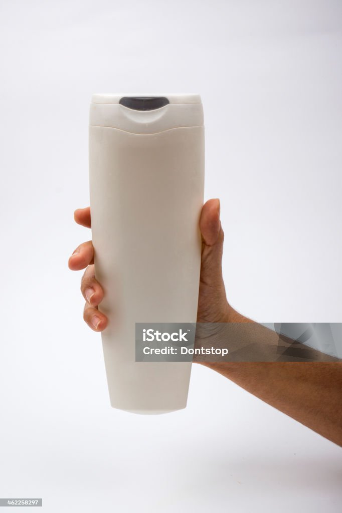 Hand with packaging Male hand holds empty shampoo packaging Color Image Stock Photo