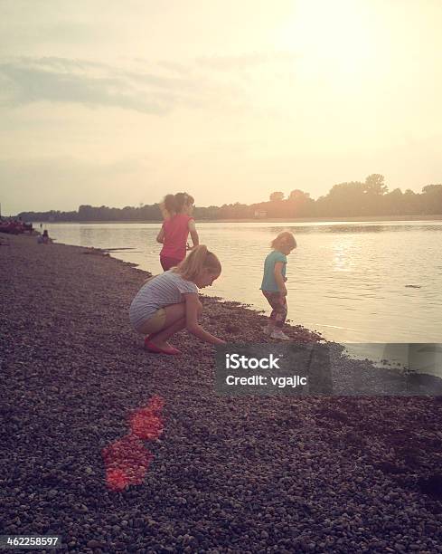 Children Skipping Stones At Local Lake Stock Photo - Download Image Now - Skipping, Stone - Object, 10-11 Years