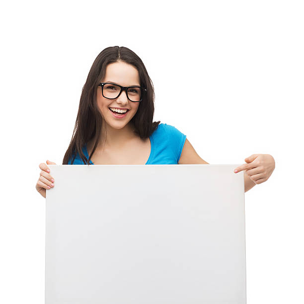 istock smiling girl with eyeglasses and white blank board 462262721