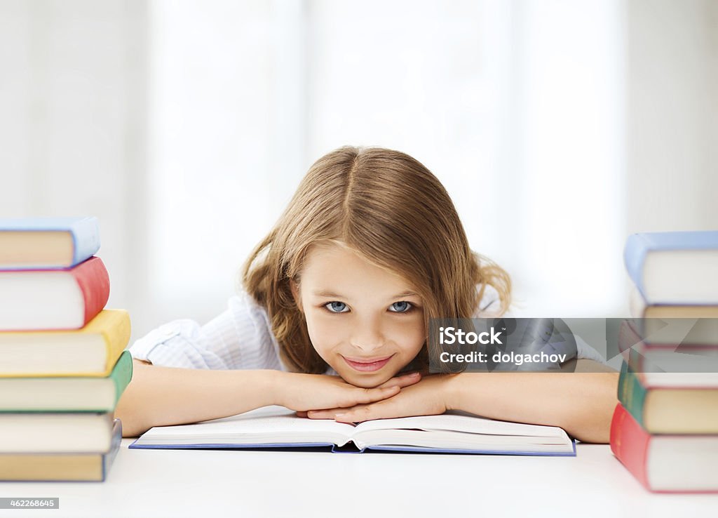 pretty girl with many books at school education and school concept - smiling little student girl with many books at school Child Stock Photo