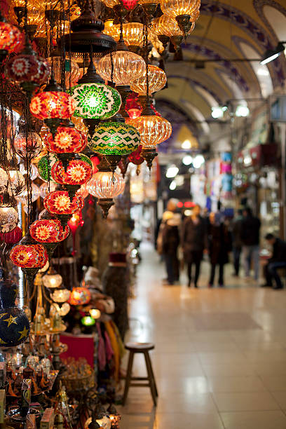 Grand Bazaar ( istanbul ) a street view of grand bazaar, focus on selective lamps at left, depth of field grand bazaar istanbul stock pictures, royalty-free photos & images