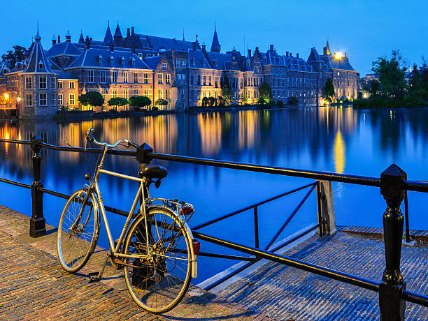 Bike on canal, The Hague Bicycle on Hofvijer canal, close to Binnenhof, The Hague, The Netherlands binnenhof photos stock pictures, royalty-free photos & images
