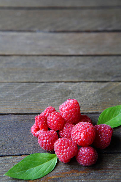 istock fresh and ripe raspberries on a wooden table 462274515