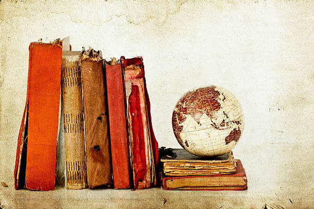 istock Five disintegrating books with a globe piled on more books 462276075