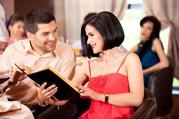istock young couple ordering food restaurant table 462283813