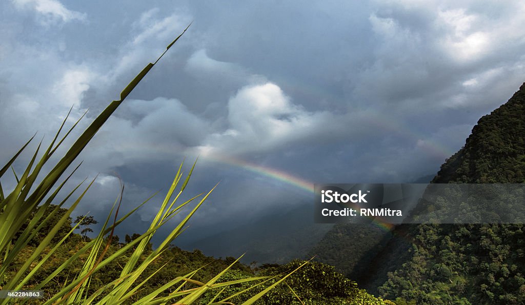 Rainbow at Zuluk (Dzuluk) village, Sikkim Rainbow on cloudy sky at Zuluk (Dzuluk) village, Sikkim Arrangement Stock Photo