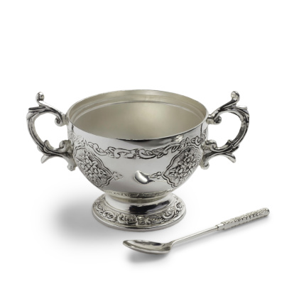 antique silver cup and spoon isolated on white background