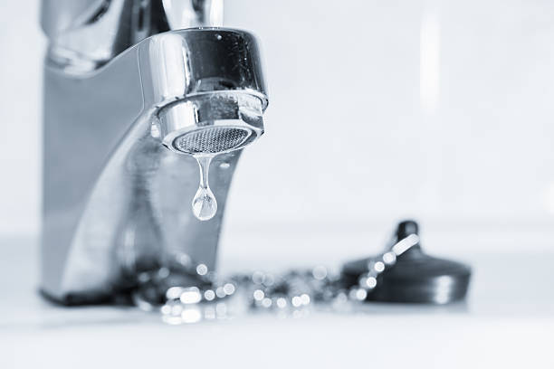 A leaking tap faucet dripping water in a sink Old faucet leak out, sink in bathroom, tinted black and white image stopper stock pictures, royalty-free photos & images