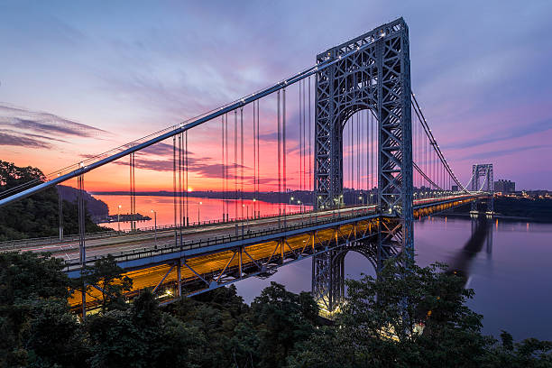 George Washington bridge at sunset The George Washington Bridge is a double-decked suspension bridge spanning the Hudson River, connecting Manhattan in New York City to New Jersey, in the United States. gwb stock pictures, royalty-free photos & images