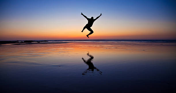 istock Silhouette of a young man jumping. 462293969