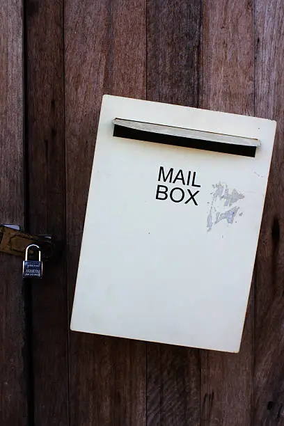 gray mailbox on old wooden door