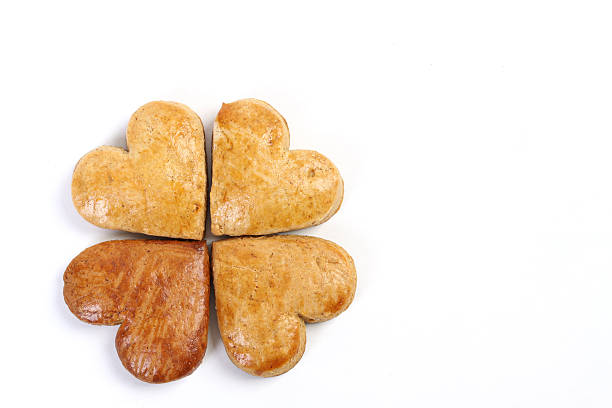 istock Four-leaf clover of gingerbread composed four hearts on white background 462296359