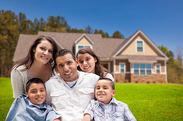 Young Hispanic Family in Front of Their New Home Happy Young Hispanic Family in Front of Their New Home. iberian ethnicity stock pictures, royalty-free photos & images