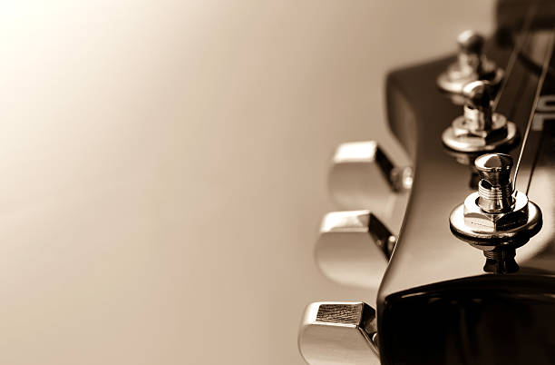 Person tuning an electric guitar. Selective focus. Copy space.