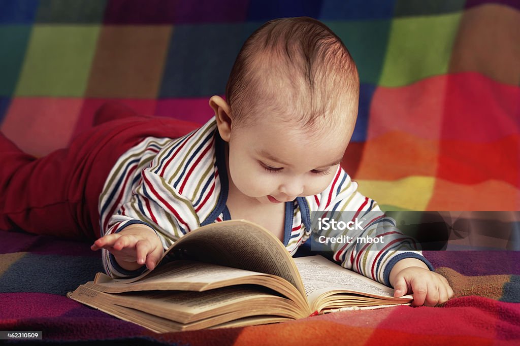 cute little baby reading book cute baby reading book on colorful background Baby - Human Age Stock Photo