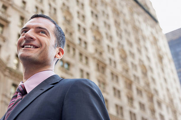 istock Businessman Smiling Against Blurred Building 462310515