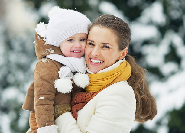 istock Mother and young daughter smiling while in the snow 462310719