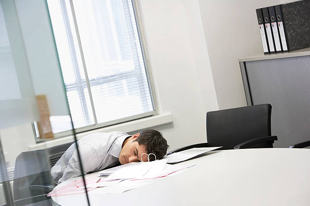 istock Businessman Asleep At Office Desk 462313413