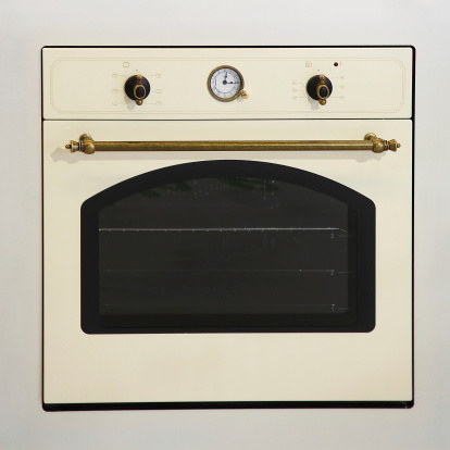 Retro style beige oven with brass details