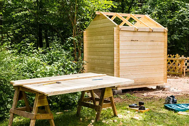 Construction of a wooden hut in a garden