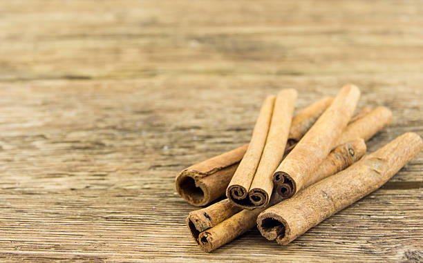 istock Close up of cinnamon sticks on rustic wood 462314605