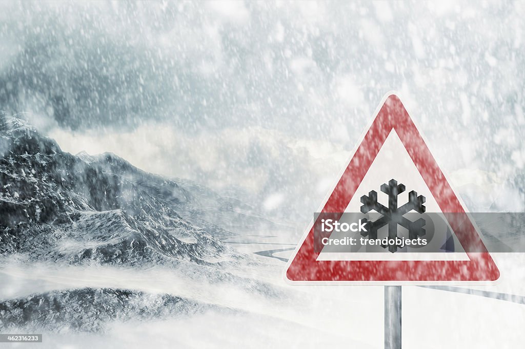 winter driving - snowfall in the mountains winter driving - snowfall in the mountains - caution - warning sign Safety Stock Photo