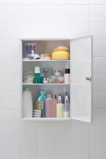 Various cosmetics and bath products in bathroom cabinet