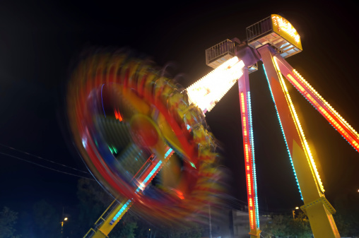 Amusement park at night with the colourful motion lights effects