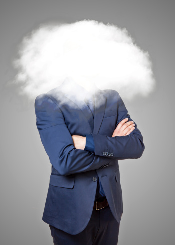 Businessman with head in the clouds on a grey background