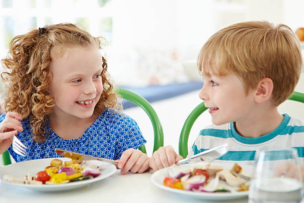 istock Two Children Eating Meal At Home Together 462326281
