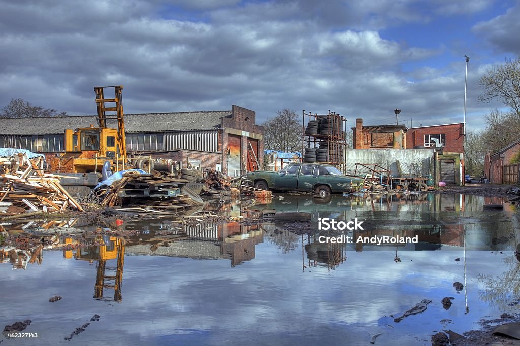 Scrapyard, England Scrapyard showing flood water and old car, Worcestershire, England. Abandoned Stock Photo