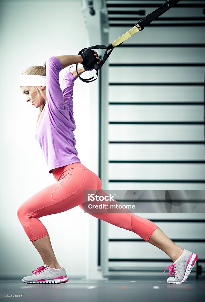 Functional training Young woman streching muscles functional training Suspension Training Stock Photo