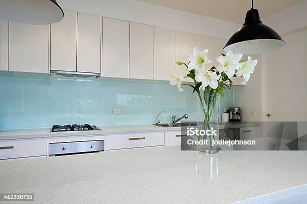 Flowers On Contemporary Kitchen Bench Stock Photo - Download Image Now - Splash Back, Kitchen, Glass - Material