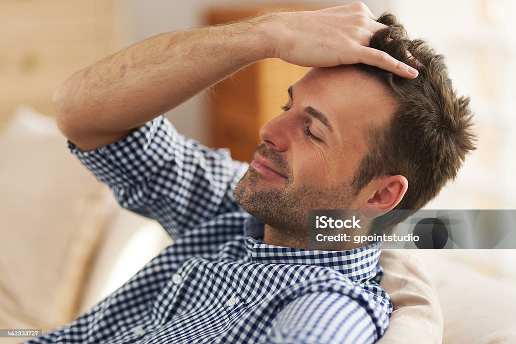 Smiling man with hand in hair Men Stock Photo