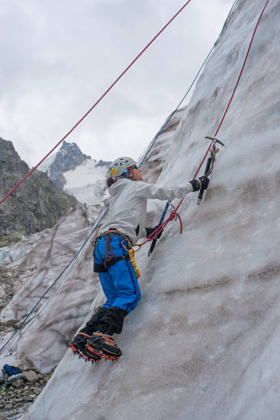 istock Girl climb up on the ice 462333743
