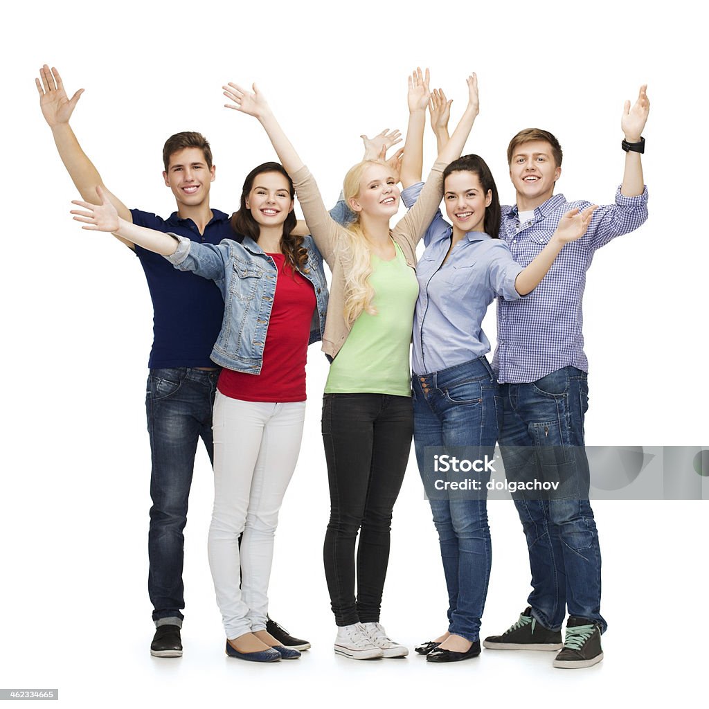 group of smiling students waving hands education, gesture, greeting and people concept - group of smiling students standing and waving hands Group Of People Stock Photo